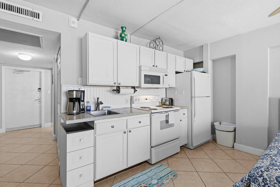 This convenient beach stay features a fully equipped kitchen with full-size appliances, perfect for extended stays by the shore. Enjoy the comfort of a well-appointed vacation rental just steps from the beach and resort amenities.