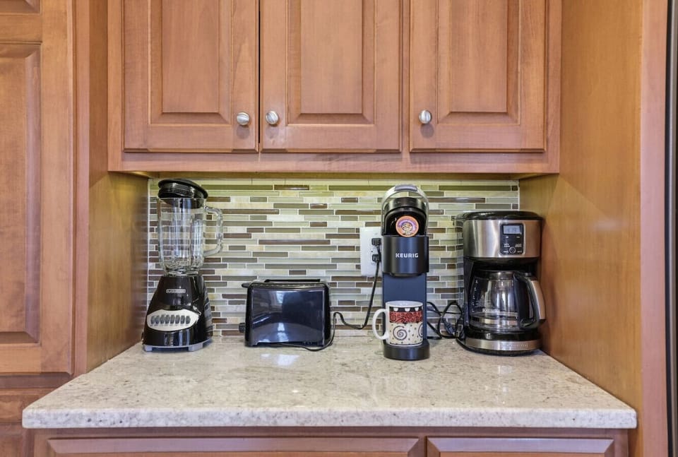 Fully stocked kitchen with everything you need: large double‑door fridge, Keurig + drip coffee, blender, toaster, microwave, dishwasher, and a spacious island. Enjoy snacks on arrival and a window-view sink that makes cooking feel easy.
