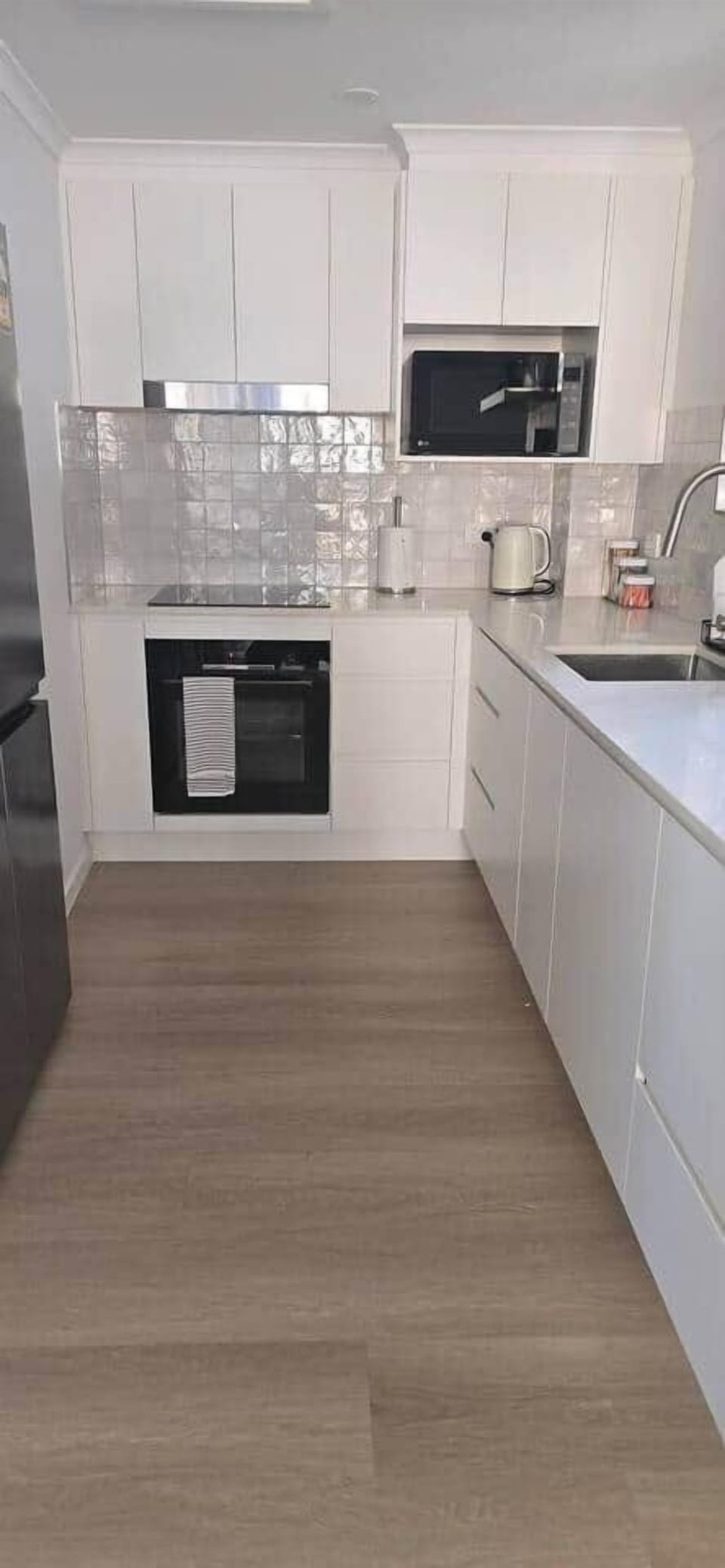 Oven, induction cooktop, coffee machine, rangehood, fridge and dishwasher