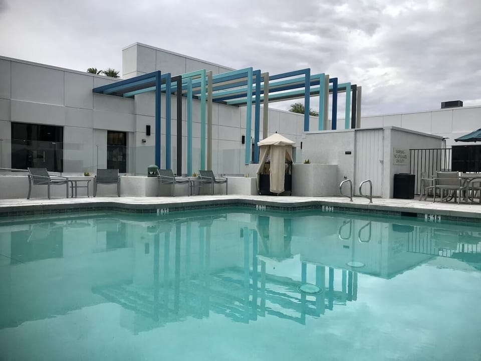 Unwind poolside with calm water and spacious loungers.