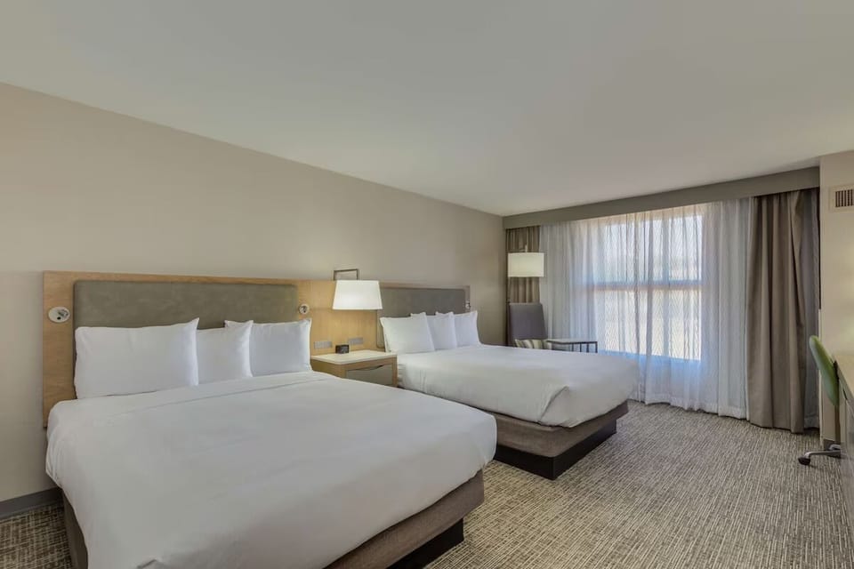 Unwind in bright double-queen comfort beside oversized windows.