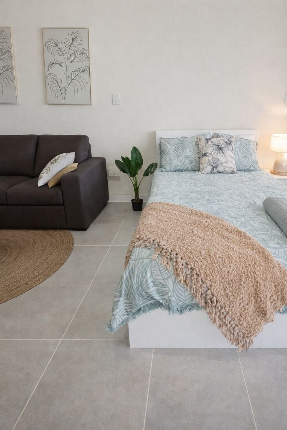 A photograph showcases a bedroom and living area w