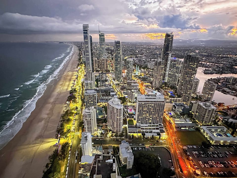 Stunning dusk and night views over Surfers Paradise, where city lights meet the coastline for an unforgettable outlook.