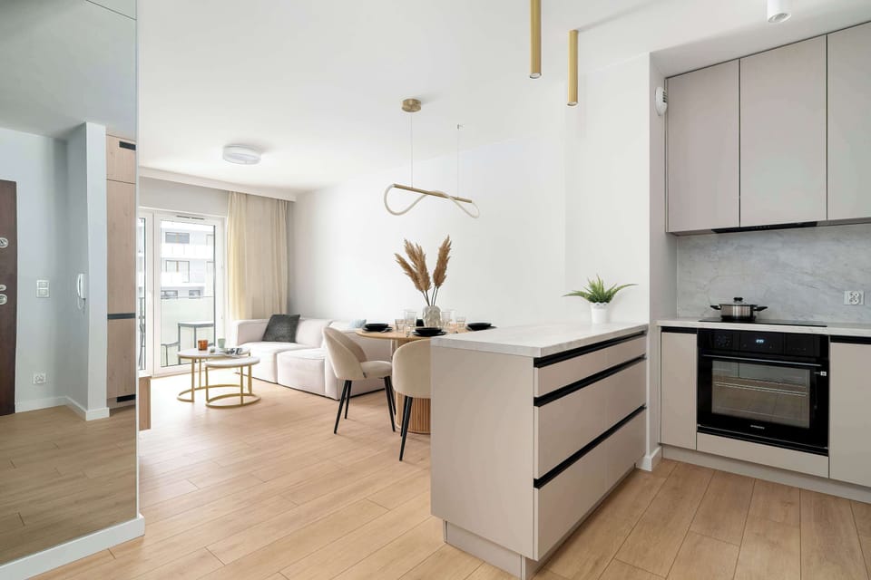 The sleek design of the kitchenette blending seamlessly with the living area.