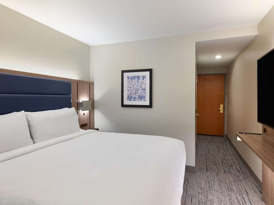 Clean king room with padded headboard and easy layout