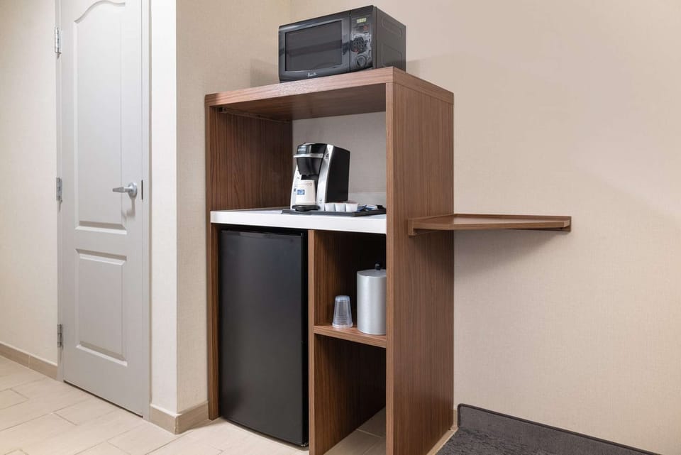 Coffee station with microwave, mini fridge, and storage shelves