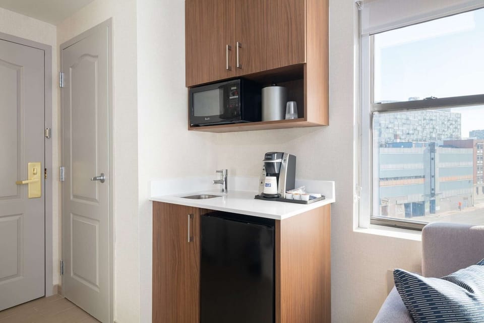 In-room kitchenette with sink, coffee maker, fridge, and microwave