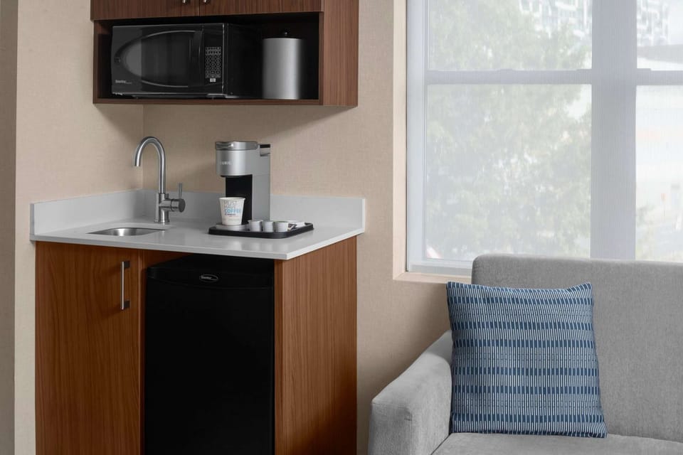 Kitchenette close-up with coffee station and storage cabinets