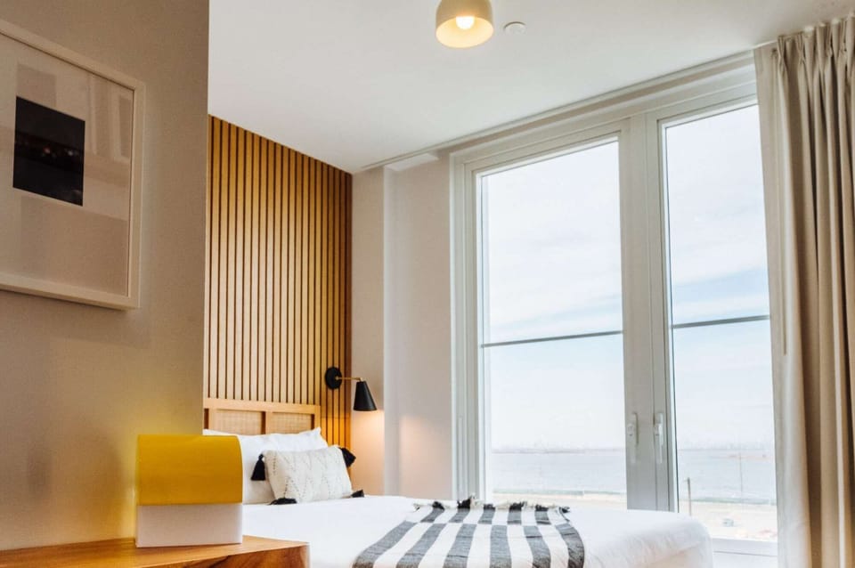 King Bed, side lamp, and wide water view