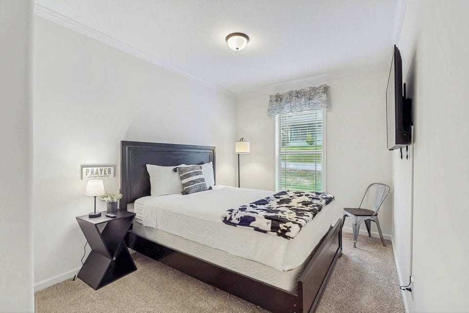 Inviting retreat with plush bedding, stylish decor, and lovely natural light!