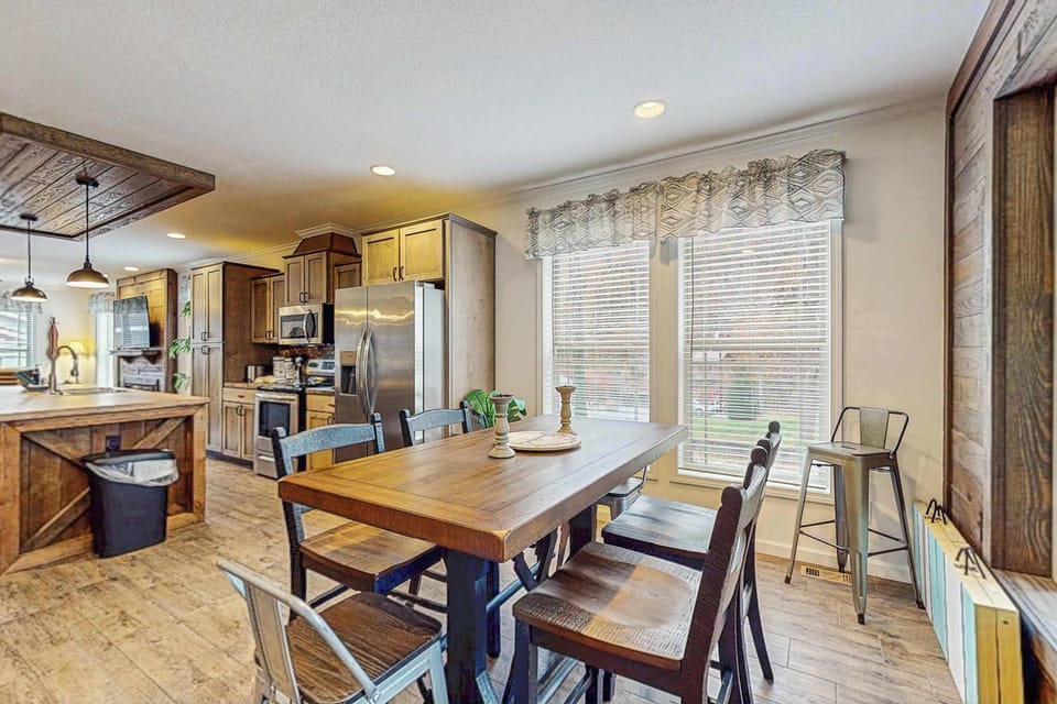 Gather around the rustic table with bright views and a stylish, open layout!