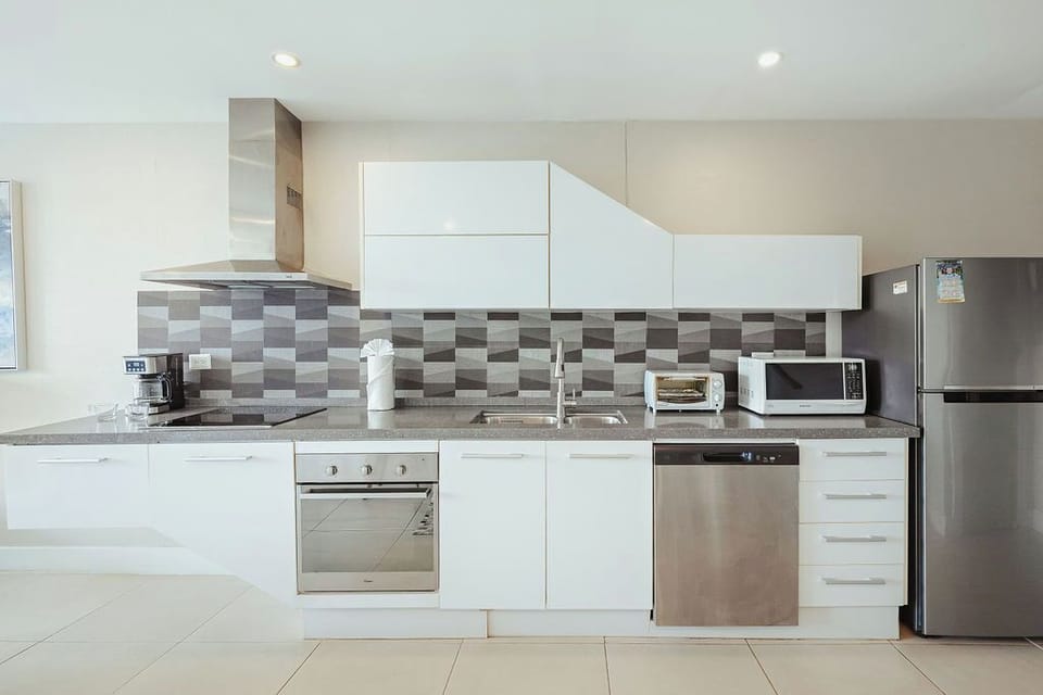 Your fully equipped kitchen awaits with modern appliances and sleek granite countertops, perfect for preparing meals during your stay.