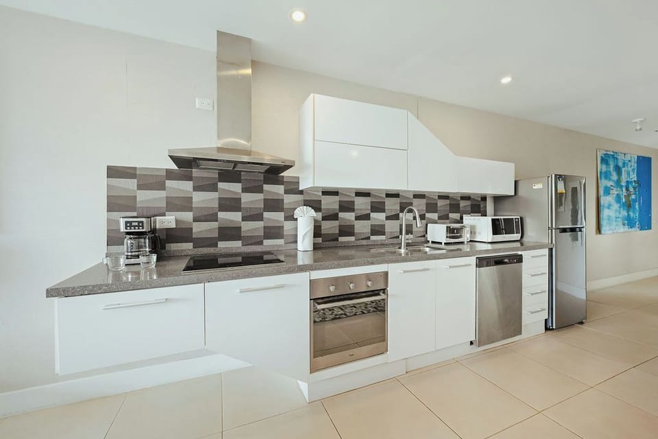 Your sleek modern kitchen features stainless steel appliances, granite countertops, and everything you need to create delicious meals during your stay.