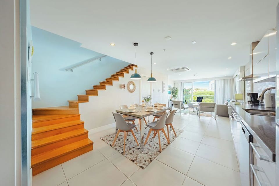 Step into your bright, open-plan sanctuary where modern elegance meets comfort. Warm wood stairs lead to private spaces above your stylish living area.