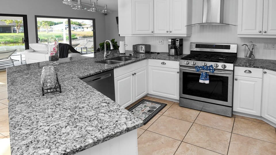 Modern open kitchen with spacious granite countertops and high quality appliances