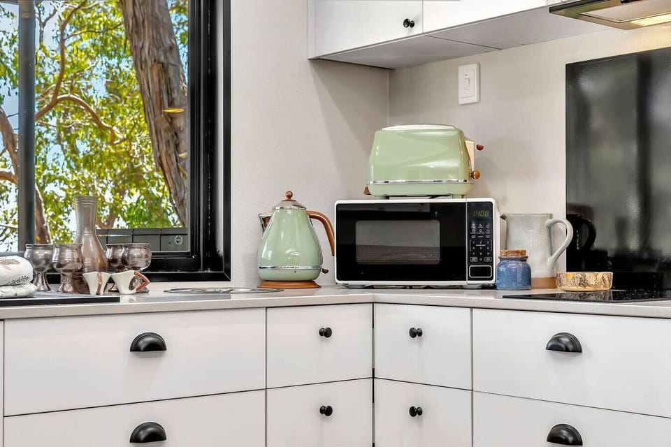 Kitchen essentials including microwave, kettle, and coffee station
