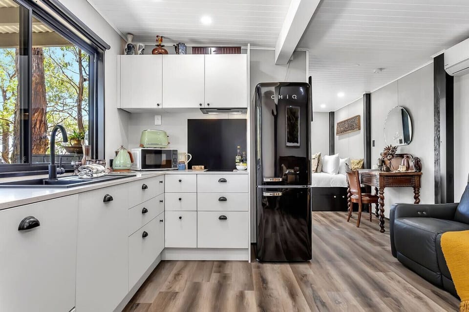 Modern kitchenette with essentials, appliances, and bushland views