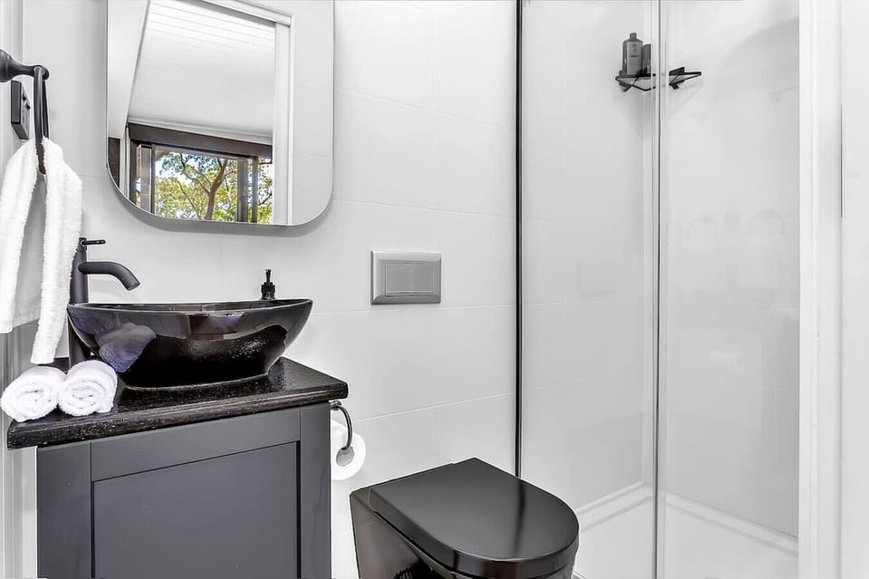 Modern bathroom with sleek black sink and plush towels