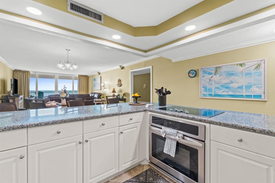 Your spacious kitchen features granite countertops and ocean views, perfect for preparing meals while soaking in coastal beauty.