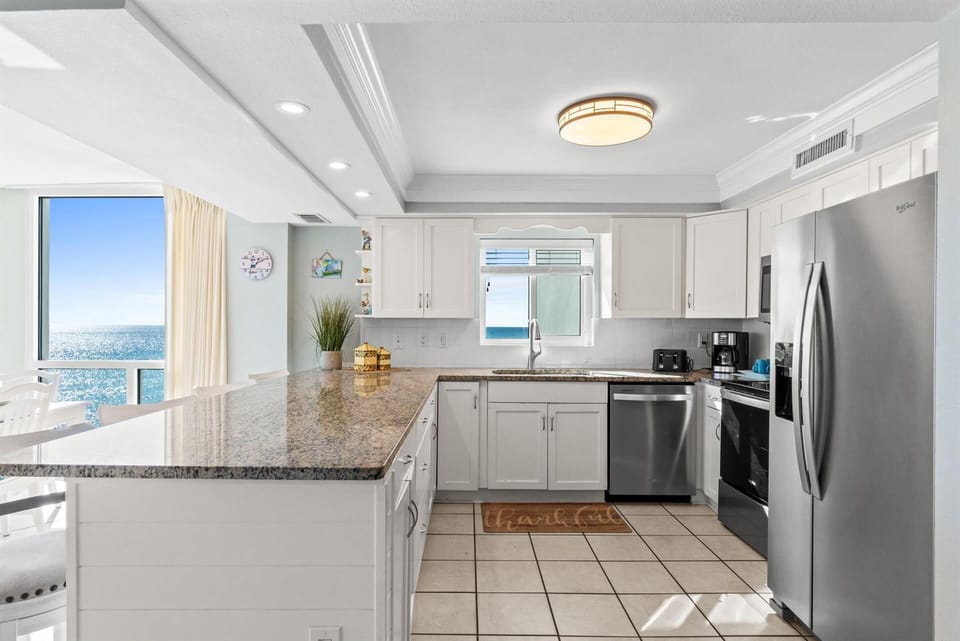 Your stunning oceanfront kitchen features granite countertops, modern appliances, and breathtaking sea views while you cook.