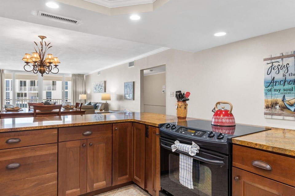 Cook your favorite meals in this spacious kitchen with granite countertops, rich wood cabinetry, and modern appliances that make every culinary adventure a joy.