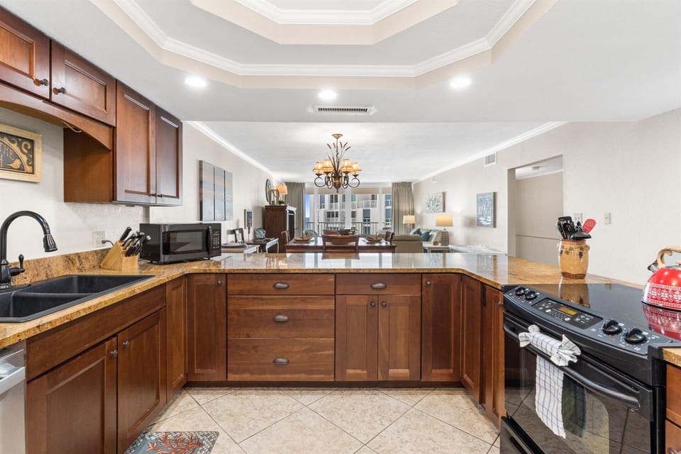 Your gourmet kitchen features rich wood cabinets, granite counters, and modern appliances—perfect for creating memorable meals during your stay.