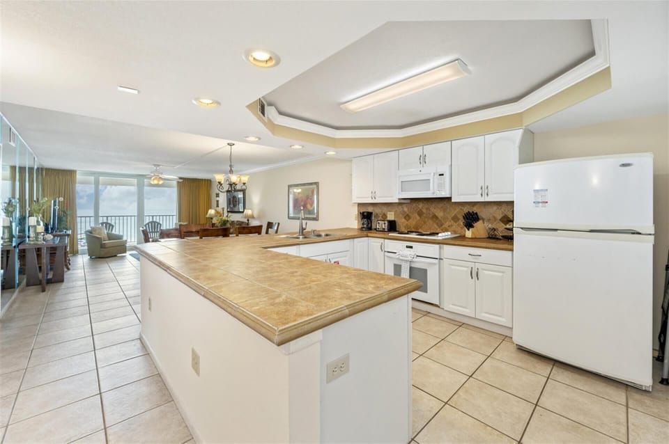 Cook with confidence in your spacious kitchen featuring granite counters and modern appliances, with stunning ocean views as your backdrop.