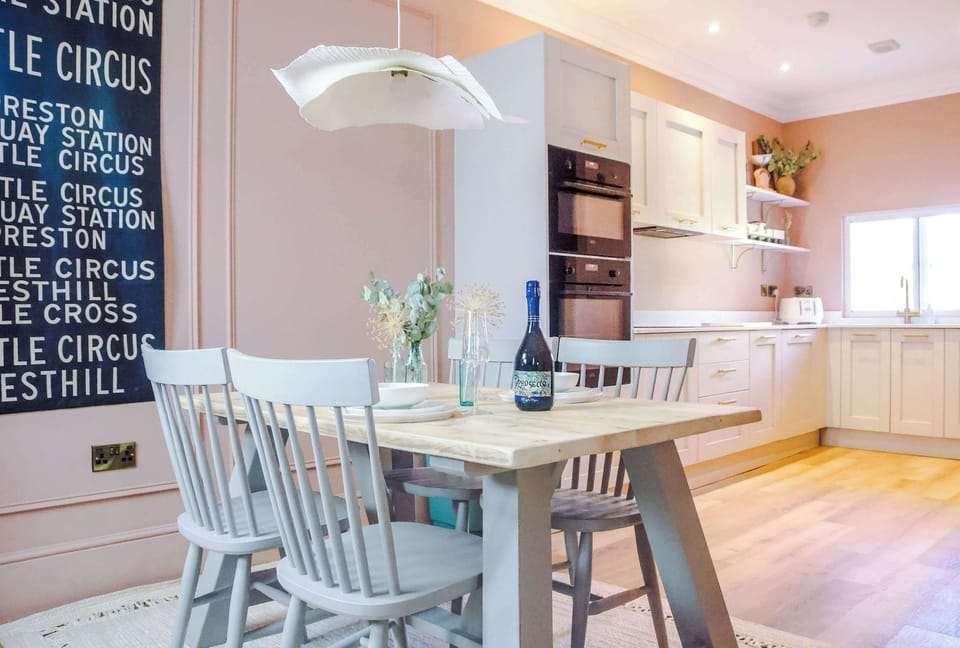 Enjoy a sleek kitchen with integrated oven, fridge, and soft neutral tones. The dining table with four chairs and pendant lighting sets the scene for gatherings. Comfortably sleeps 7, ideal for families or long‑term stays.