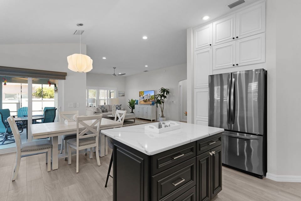 Your fully equipped kitchen flows seamlessly into the dining and living areas, creating the perfect space for preparing meals and gathering together.