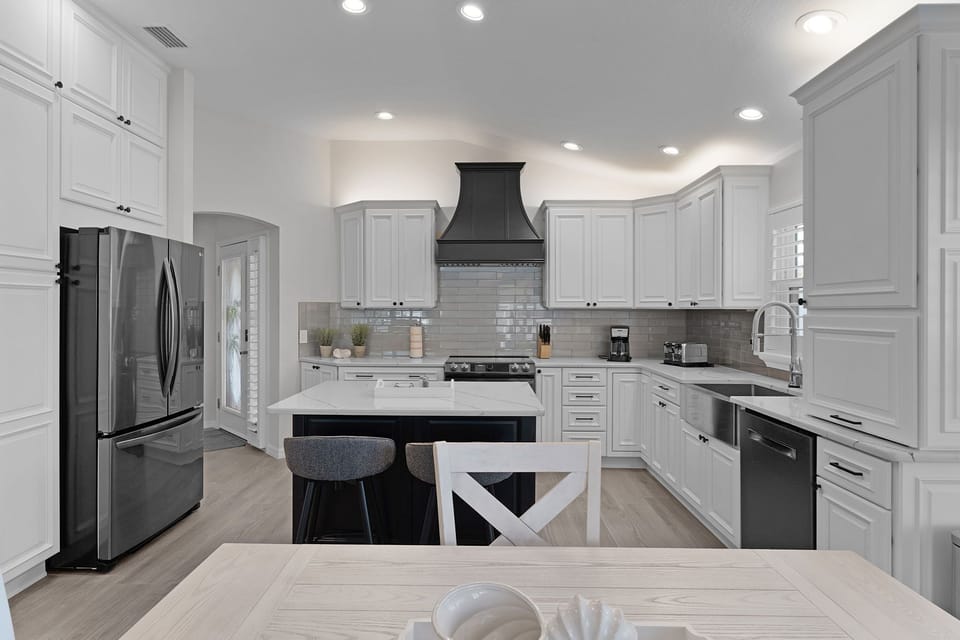 Your dream kitchen awaits with gleaming white cabinets, marble countertops, and premium stainless steel appliances perfect for creating memorable meals.