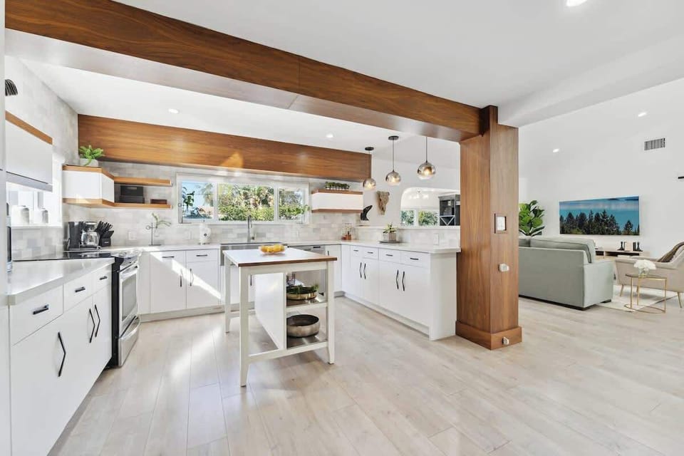 Modern open kitchen with a spacious breakfast bar, comfortable counter seating, and stylish pendant lighting—perfect for casual meals and conversation.