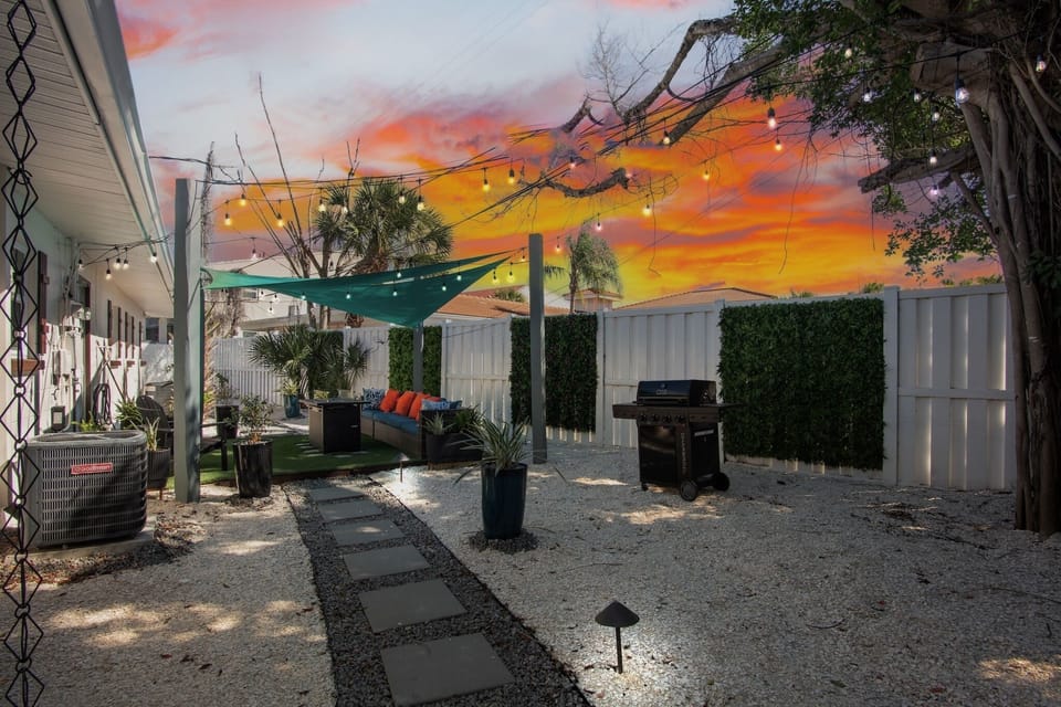 Shared backyard with comfortable seating and BBQ grill