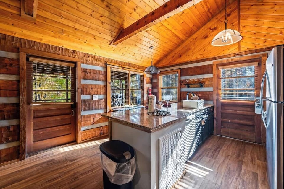 Sunlight streams through every window — a bright, airy space to cook, sip coffee, or plan your next Smoky Mountain adventure.