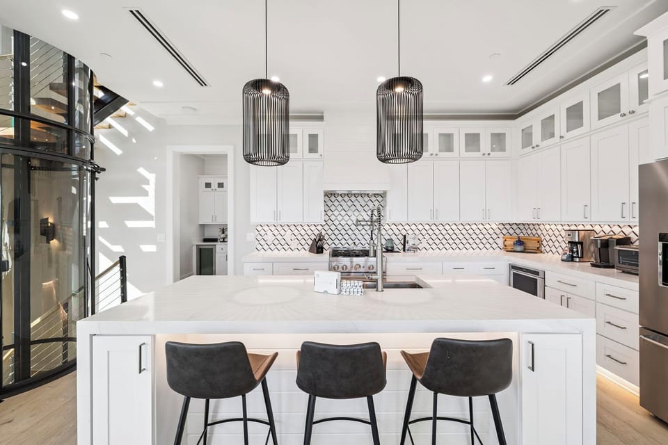 Your modern kitchen awaits with gleaming countertops, designer pendant lights, and everything you need to create memorable meals together.