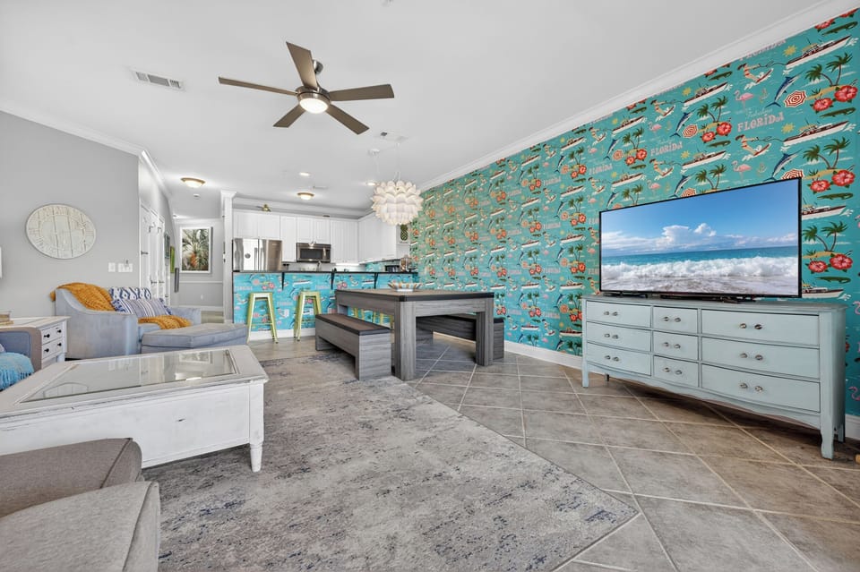 Large 65" TV with the kitchen in the background. This is on the main floor.