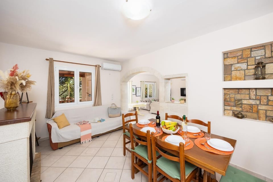 Dining area with A/C, sofa, and ornamental fireplace