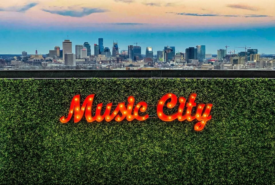 Music City neon glows against the Nashville skyline at dusk, this is where your crew gathers for those rooftop moments you'll never forget