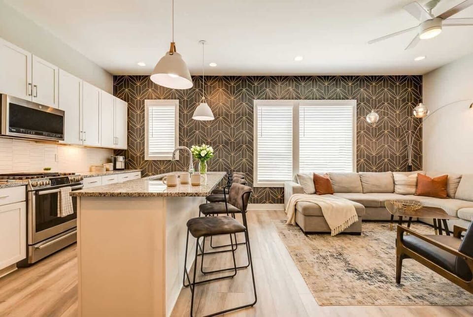 Patterned accent wall and spacious sectional give your group a living room big enough for a full house gathering without cramping