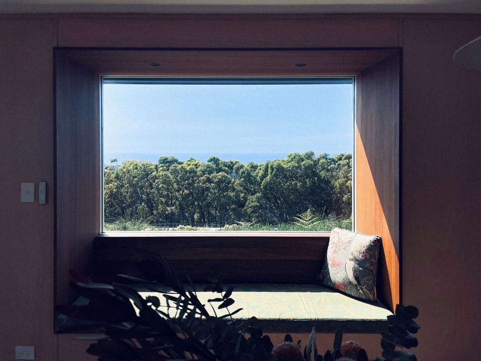 The window seat with it's golden mean framed view of the bush and ocean