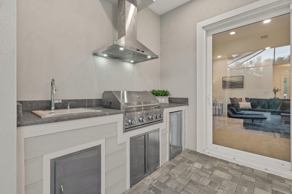 Your outdoor kitchen area is complete with comfy outdoor dining.