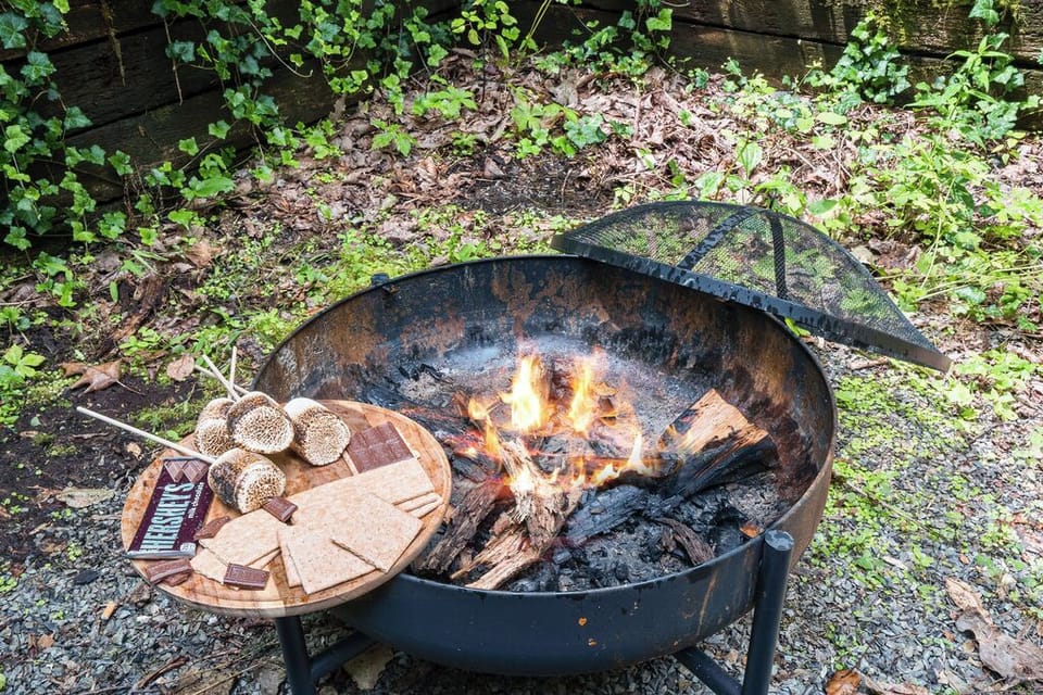 Cozy outdoor fire pit with s’mores setup for memorable evenings