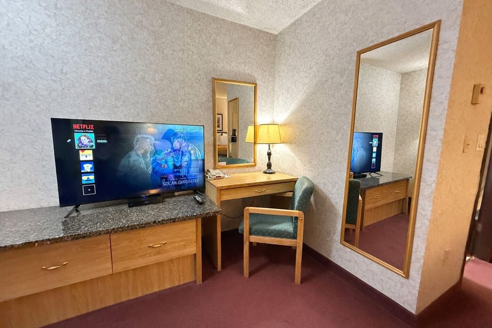 Desk, laptop workspace, blackout drapes, iron/ironing board