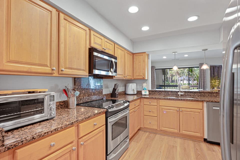 A spacious, well-appointed kitchen with ample counter space, modern appliances, and everything needed to prepare meals at home.