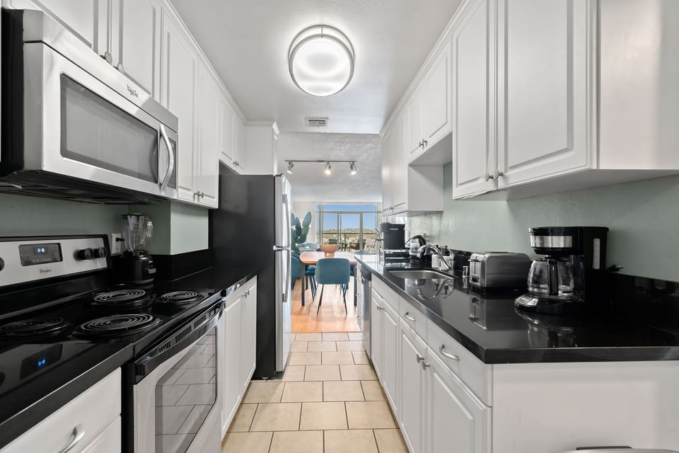 Fully-equipped kitchen with granite counters and stainless steel appliances.