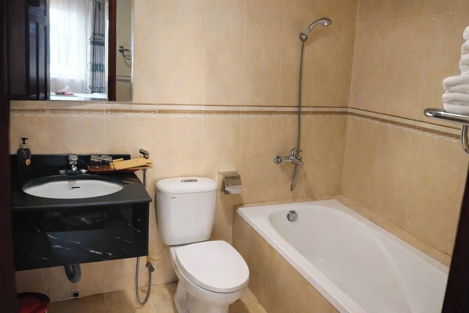 Deluxe Triple Room | Bathroom | Hair dryer, towels, soap, shampoo