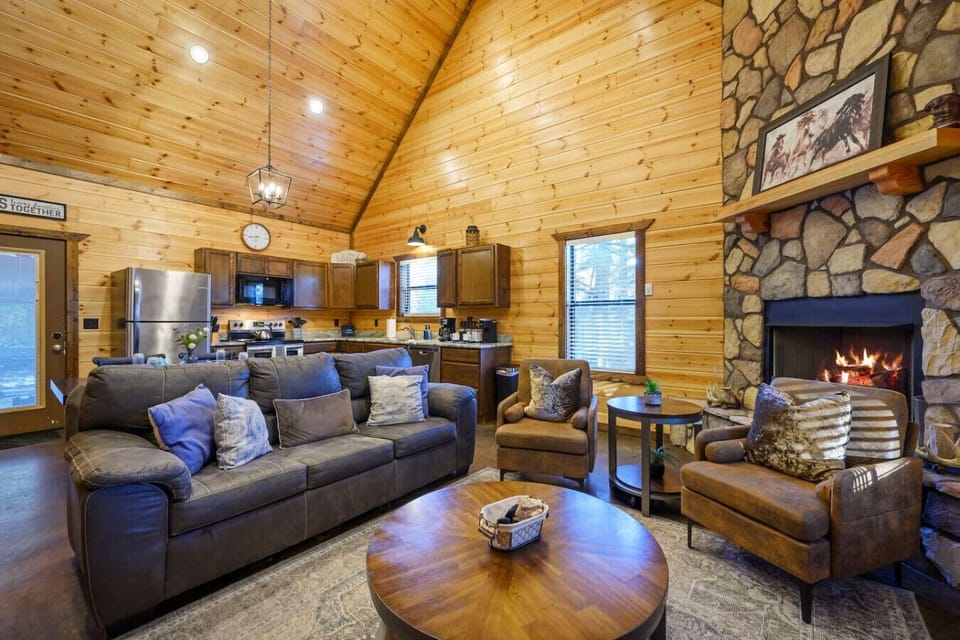 This cozy log cabin has everything you need with a stone fireplace, full kitchen, and comfortable seating for the whole crew.