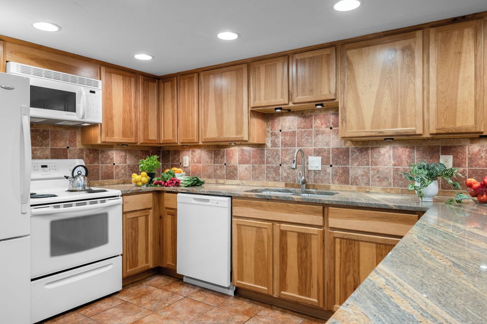 Fully equipped kitchen featuring honey-oak cabinetry and ample counter space for meal prep.