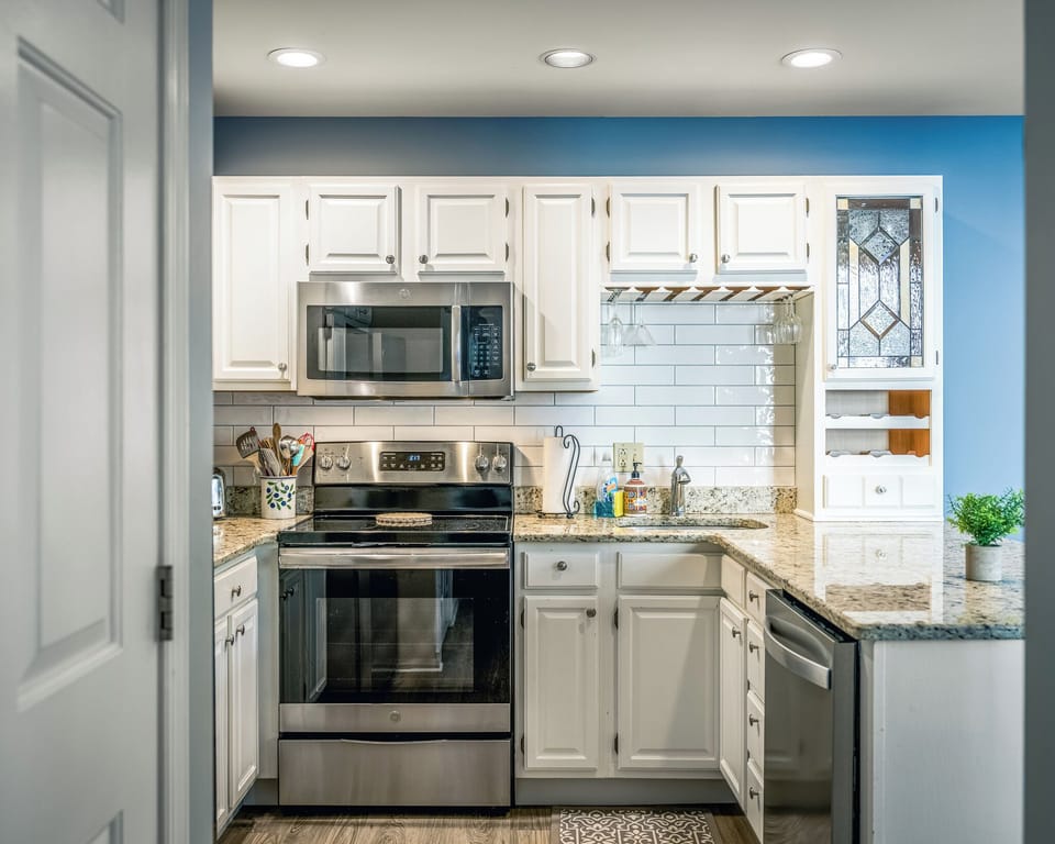 A fully equipped kitchen with granite countertops and bar seating, perfect for easy meals and casual gatherings.