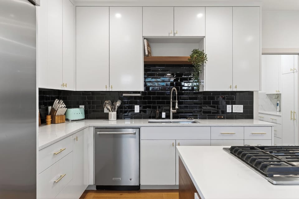 Sleek chef’s kitchen with a spacious island, modern appliances, and stylish pendant lighting.