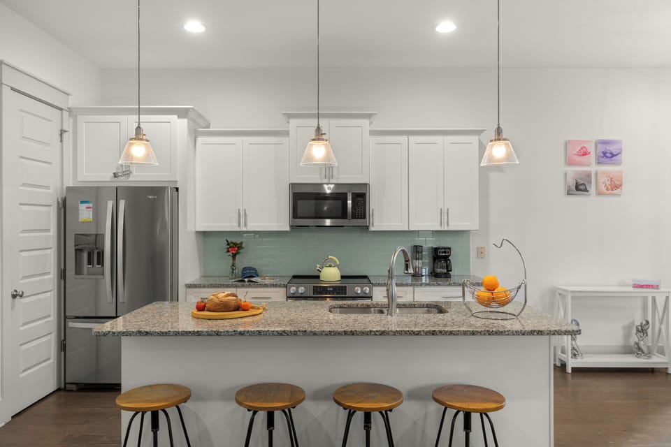 Fully equipped kitchen featuring a large island and bar seating for casual meals.